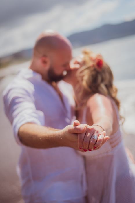 Pamela and Tanner kissing, engagement ring in focus