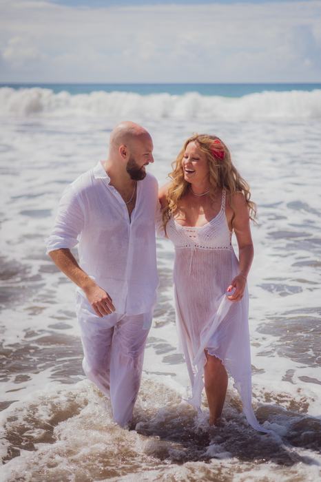 Pamela and Tanner laughing in the surf